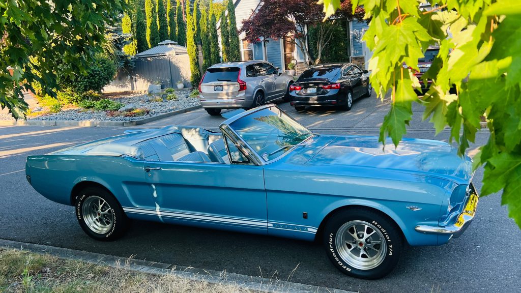 1966 Ford Mustang GT Convertible photographed from above with the top down and chrome trim in the sun