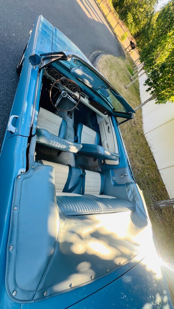 Overhead view into the 1966 Ford Mustang GT Convertible cabin showing the white interior and dashboard